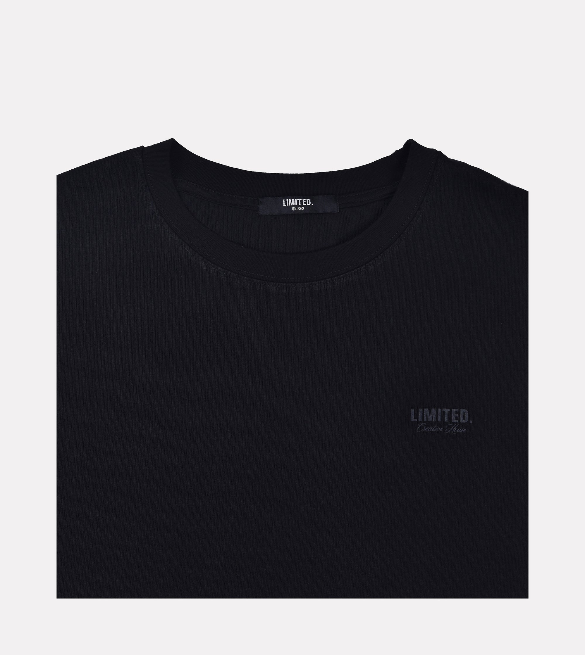 Close-up LIMITED. Oversized mens t-shirt front view in black with black small branding on the left chest.