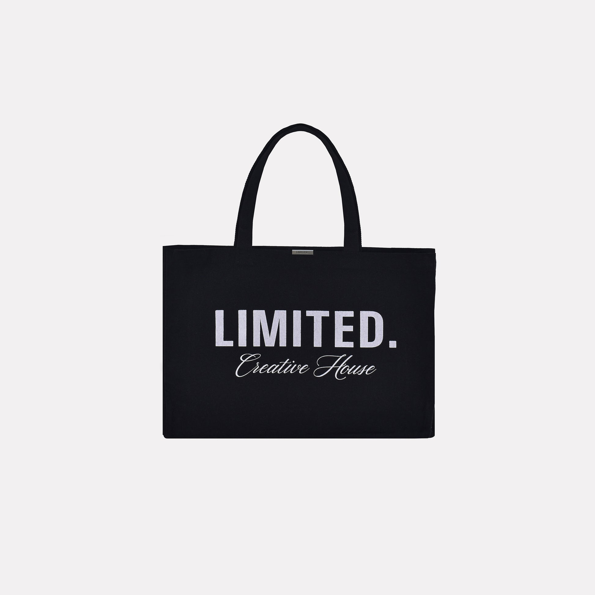 Signature LIMITED. Tote Bag in black. Minimalistic streetwear style tote bag with white LIMITED. branding print.