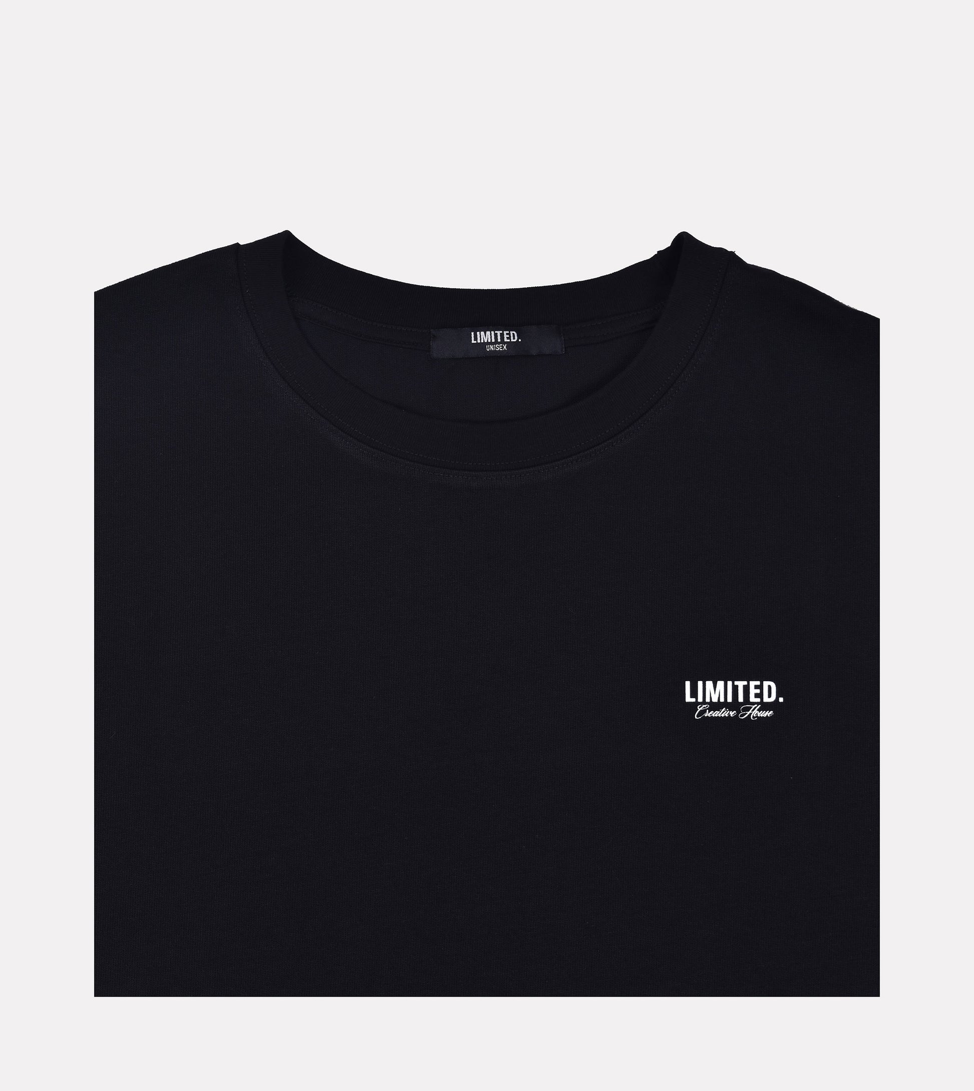 Close-up LIMITED. Oversized mens t-shirt front view in black with white small branding on the left chest.